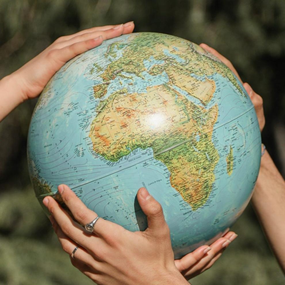 Earth globe held by two hands