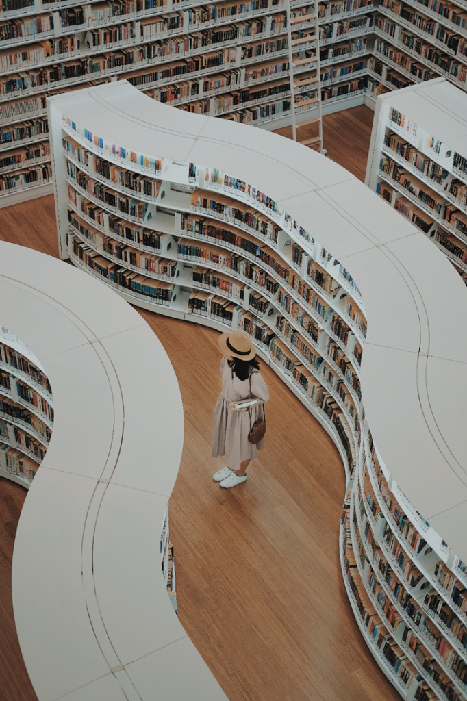 Woman walking in a library, picture taken from above
