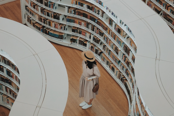 Woman walking in a library, picture taken from above